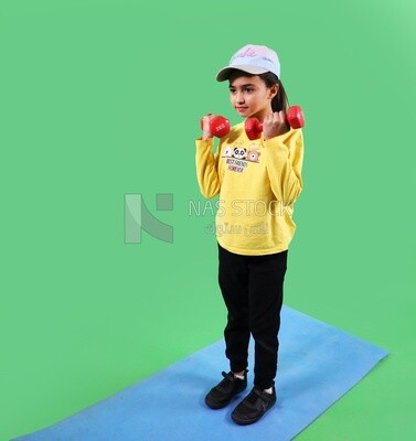 A girl holding dumbbells