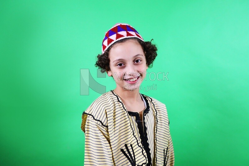 A boy standing on a green background