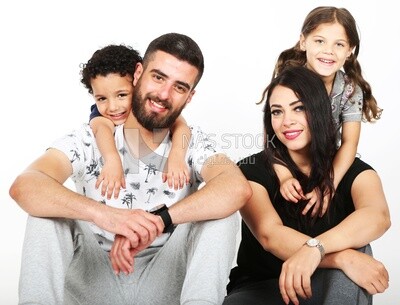 A family of four sitting on the floor
