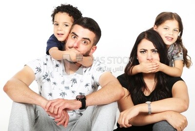 A family of four sitting on the floor