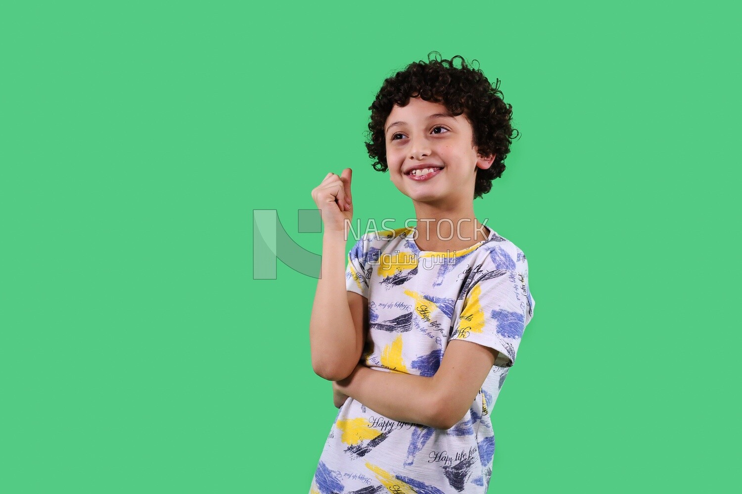 A boy standing on a green background