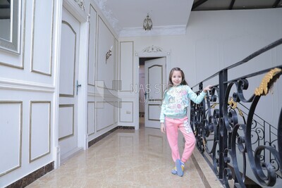 a girl standing in the living room