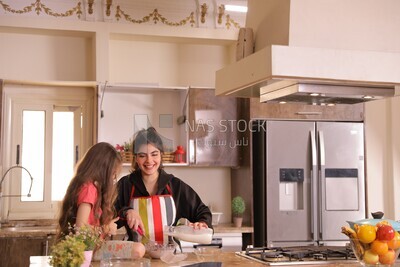 a mother with her girl in the kitchen