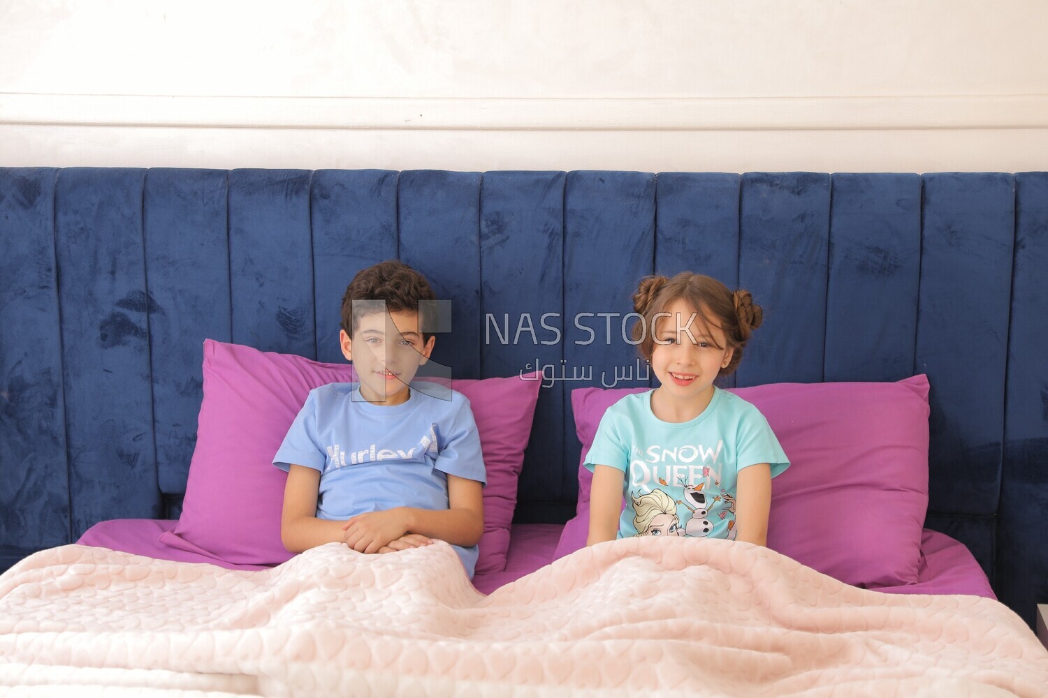 a brother and his sister lying in bed