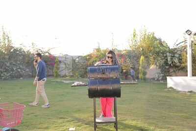 woman preparing food on a barbecue grill