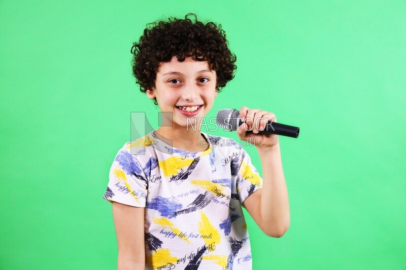 A boy holding a microphone