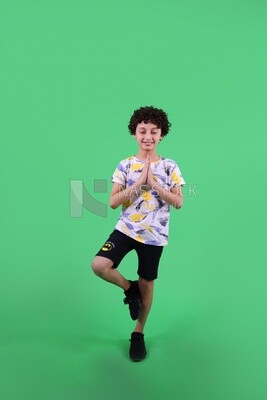 A boy standing on a green background