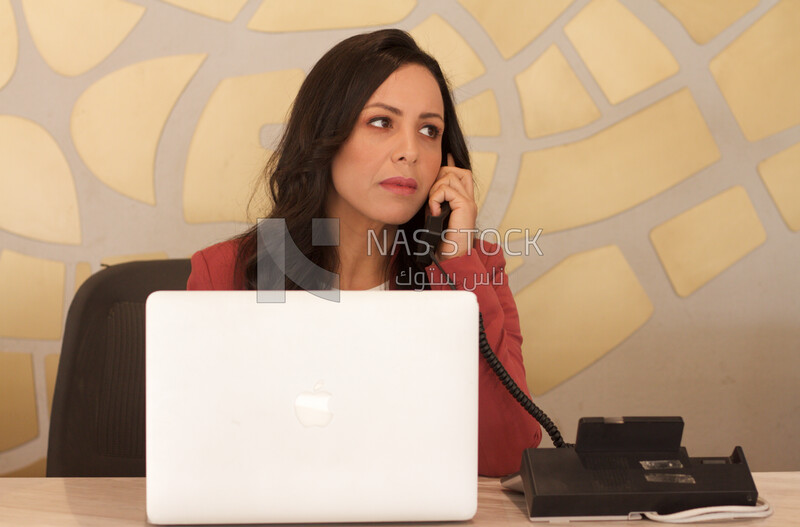 An Egyptian girl sitting at the desk
