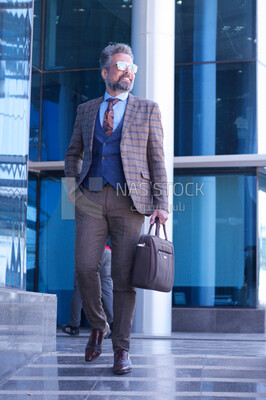 A man holding a leather bag
