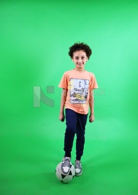 A boy standing with a soccer ball