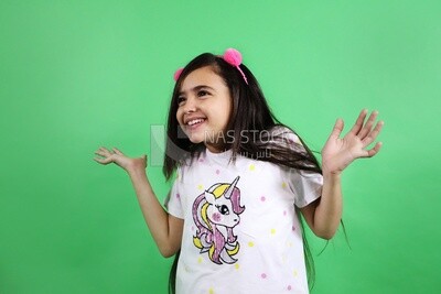 A small girl standing on a green background