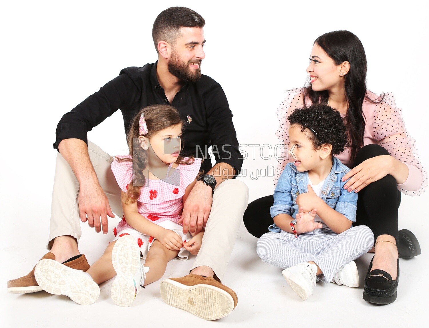 A family of four sitting on the floor