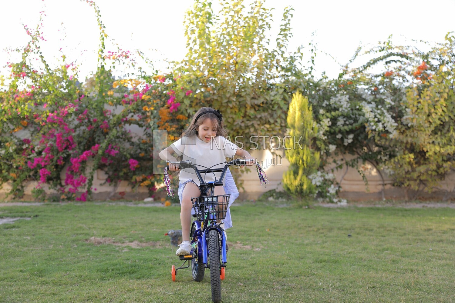 a girl riding a bike in the garden