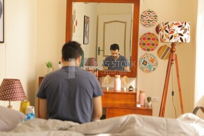 a man  sitting in bed waking up