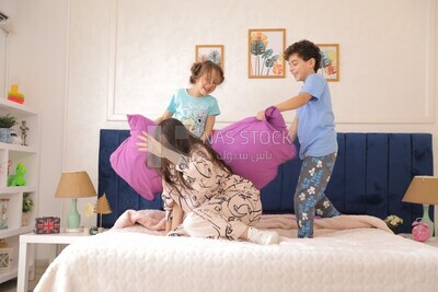 a woman sitting with her children playing