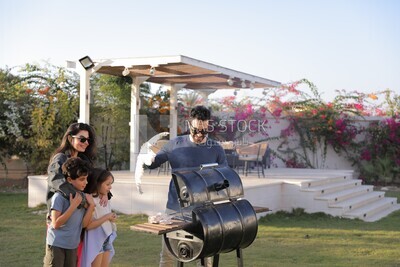 man preparing food on a barbecue grill