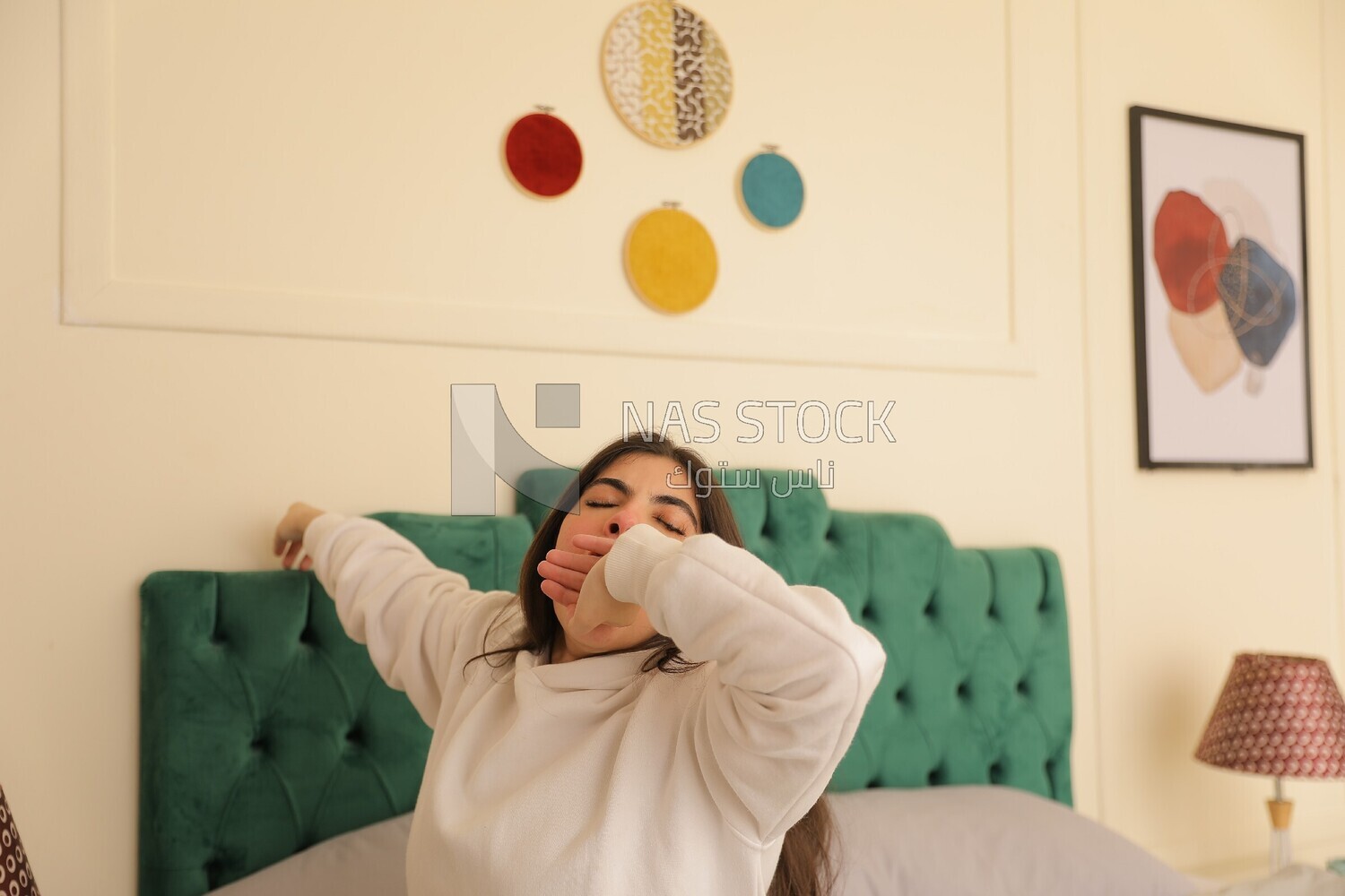 a woman sitting in bed waking up