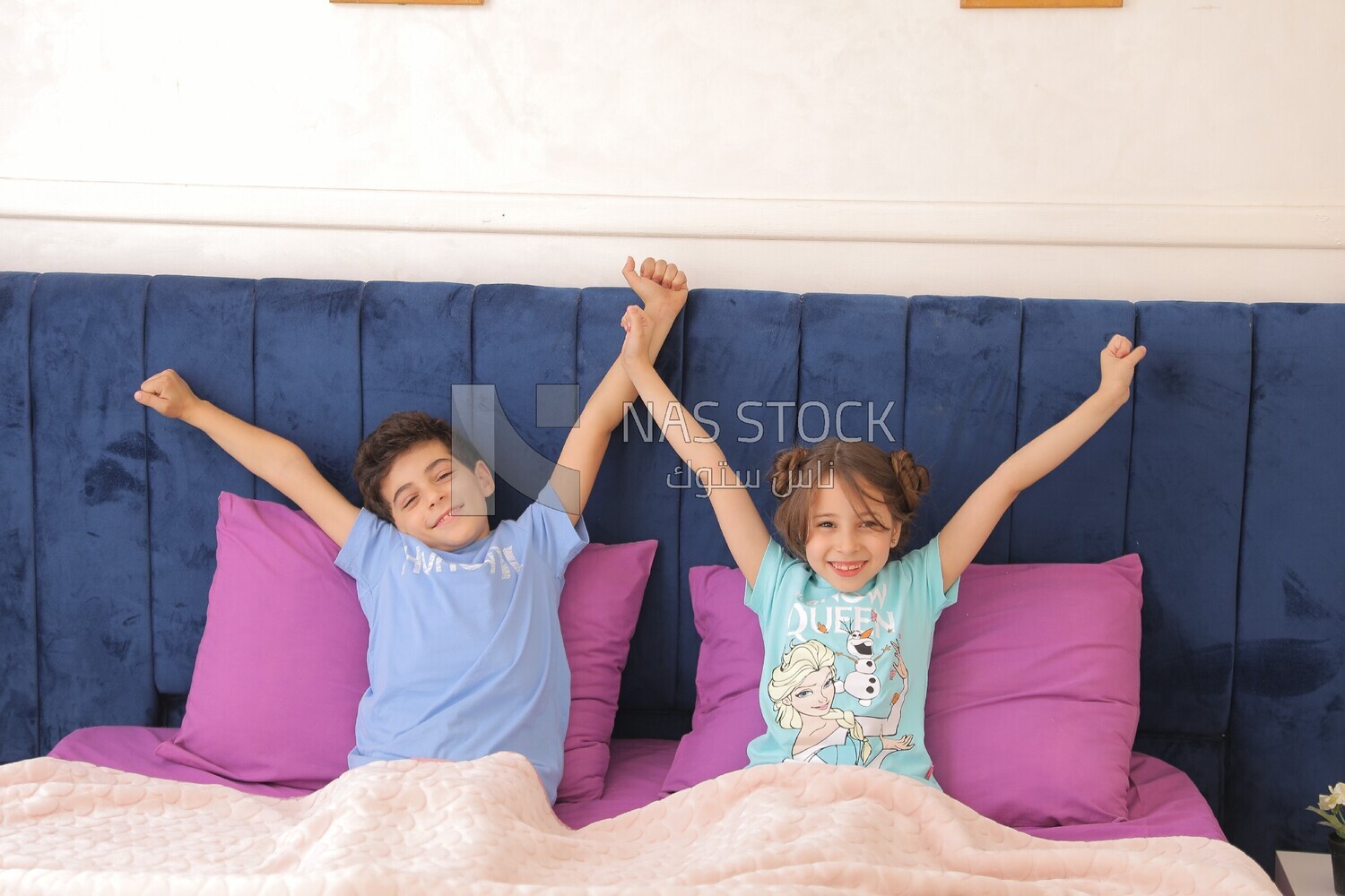 a brother and his sister lying in bed