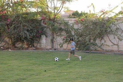 a boy playing football in the garden