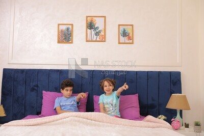 a brother and his sister lying in bed