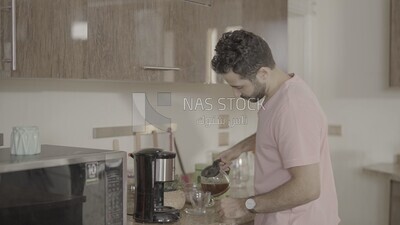 a man puts the coffee in the cup