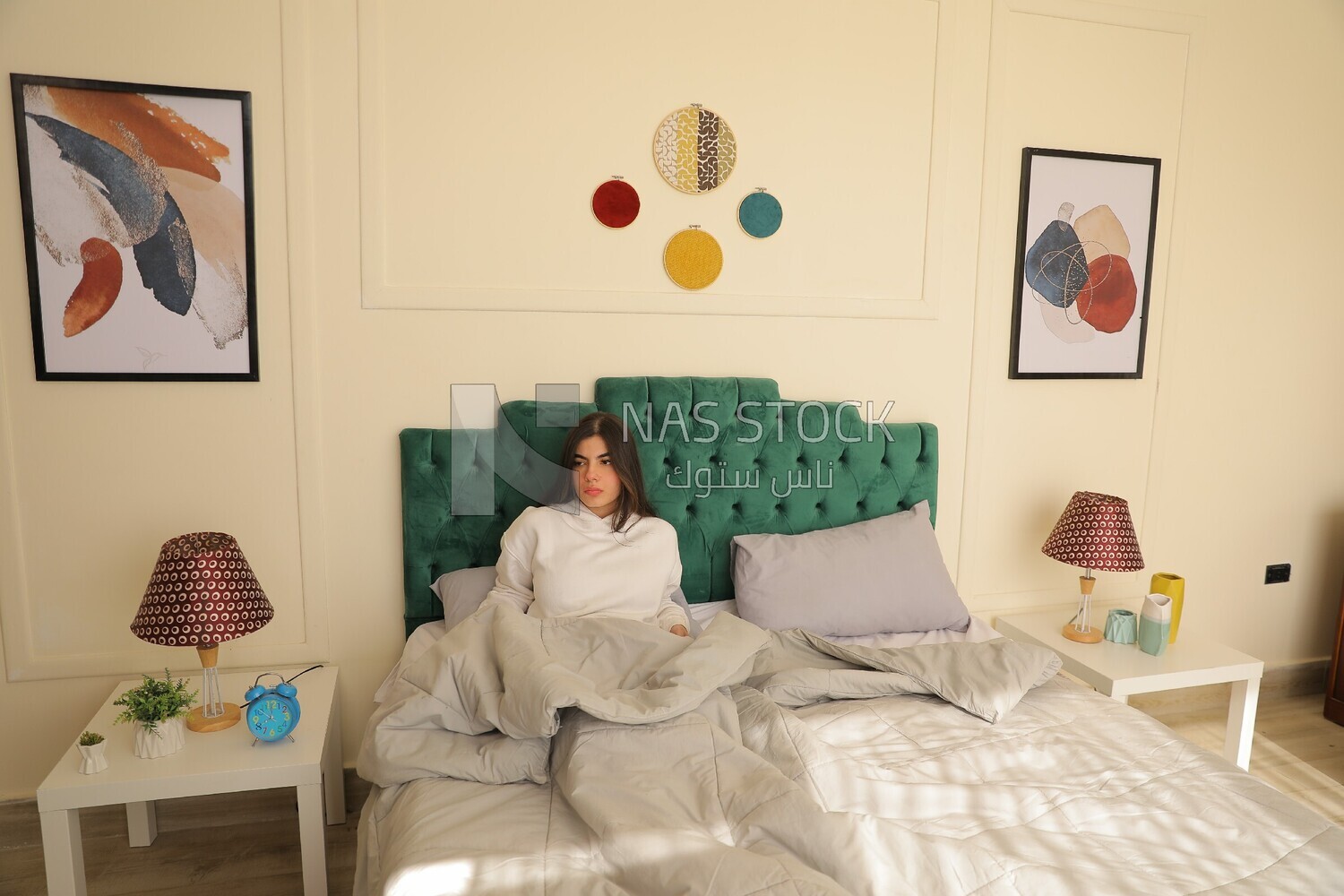 a woman sitting in bed waking up