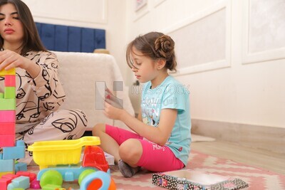 a girl putting on make up while she plays