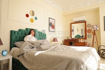a woman sitting in bed waking up