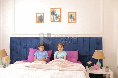 a brother and his sister lying in bed
