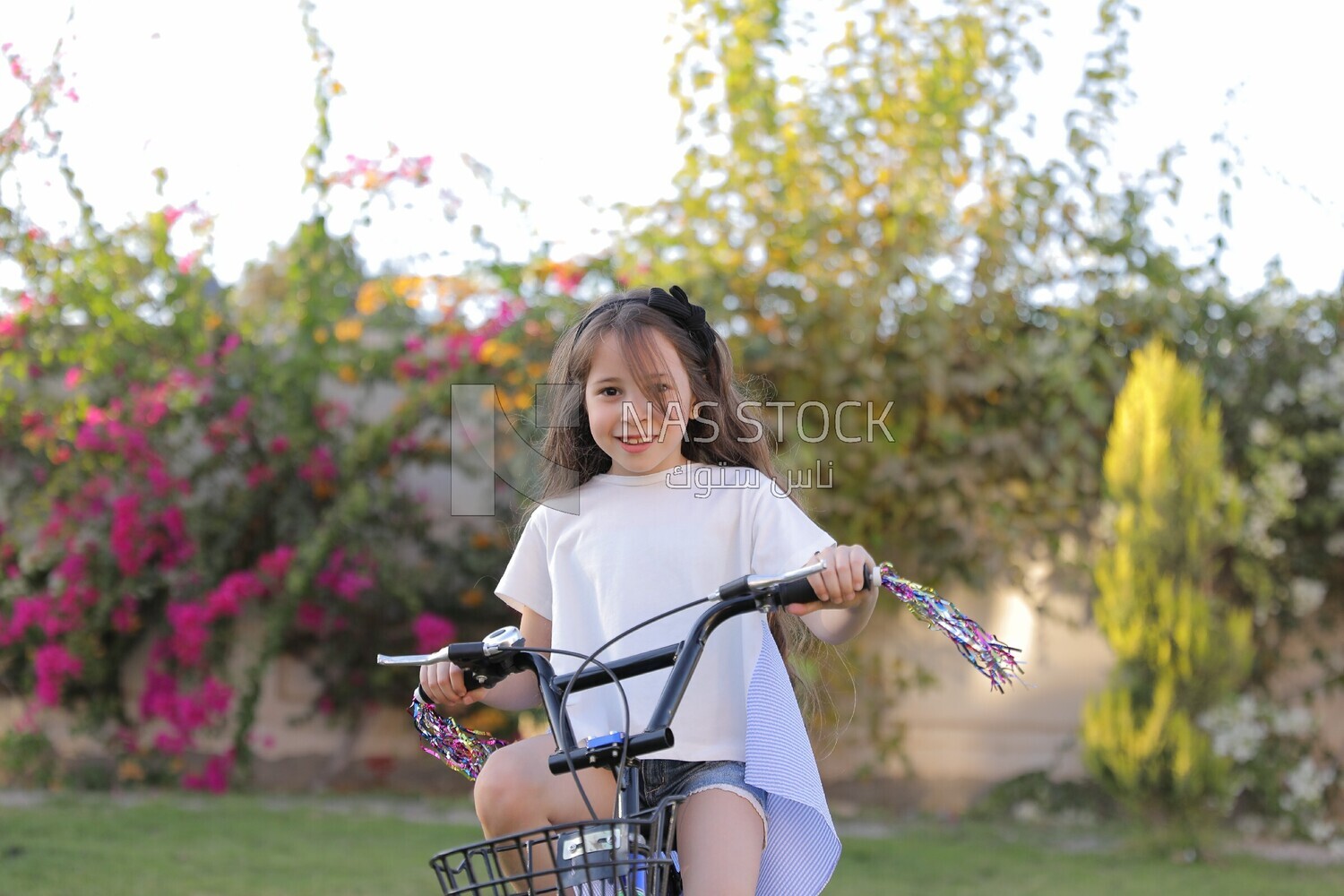 a girl riding a bike in the garden