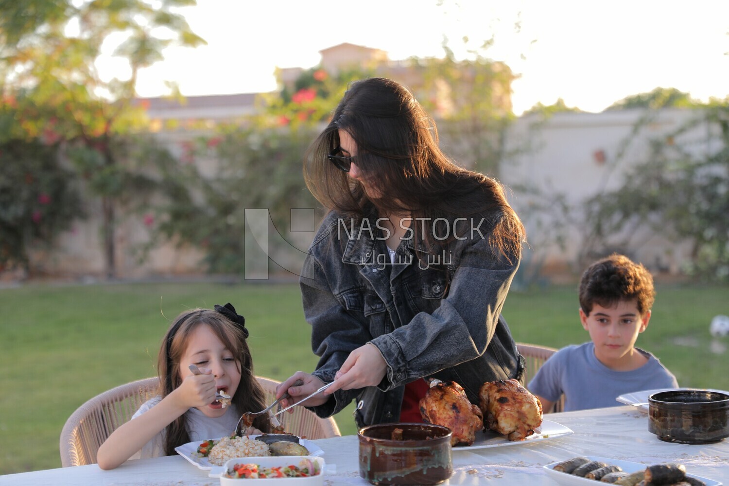 a mother feeding her daughter