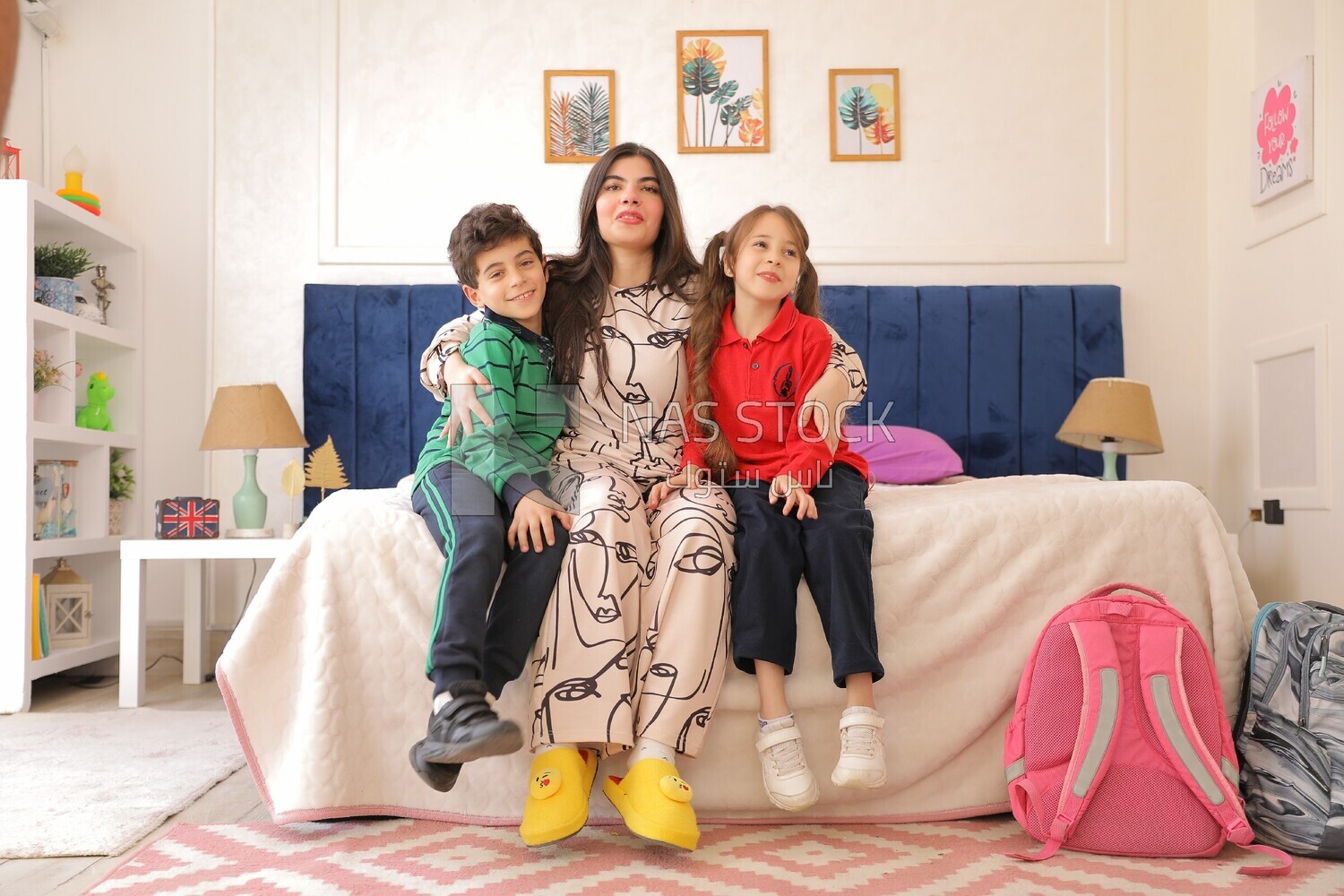 a mother hugging her kids before going to the school