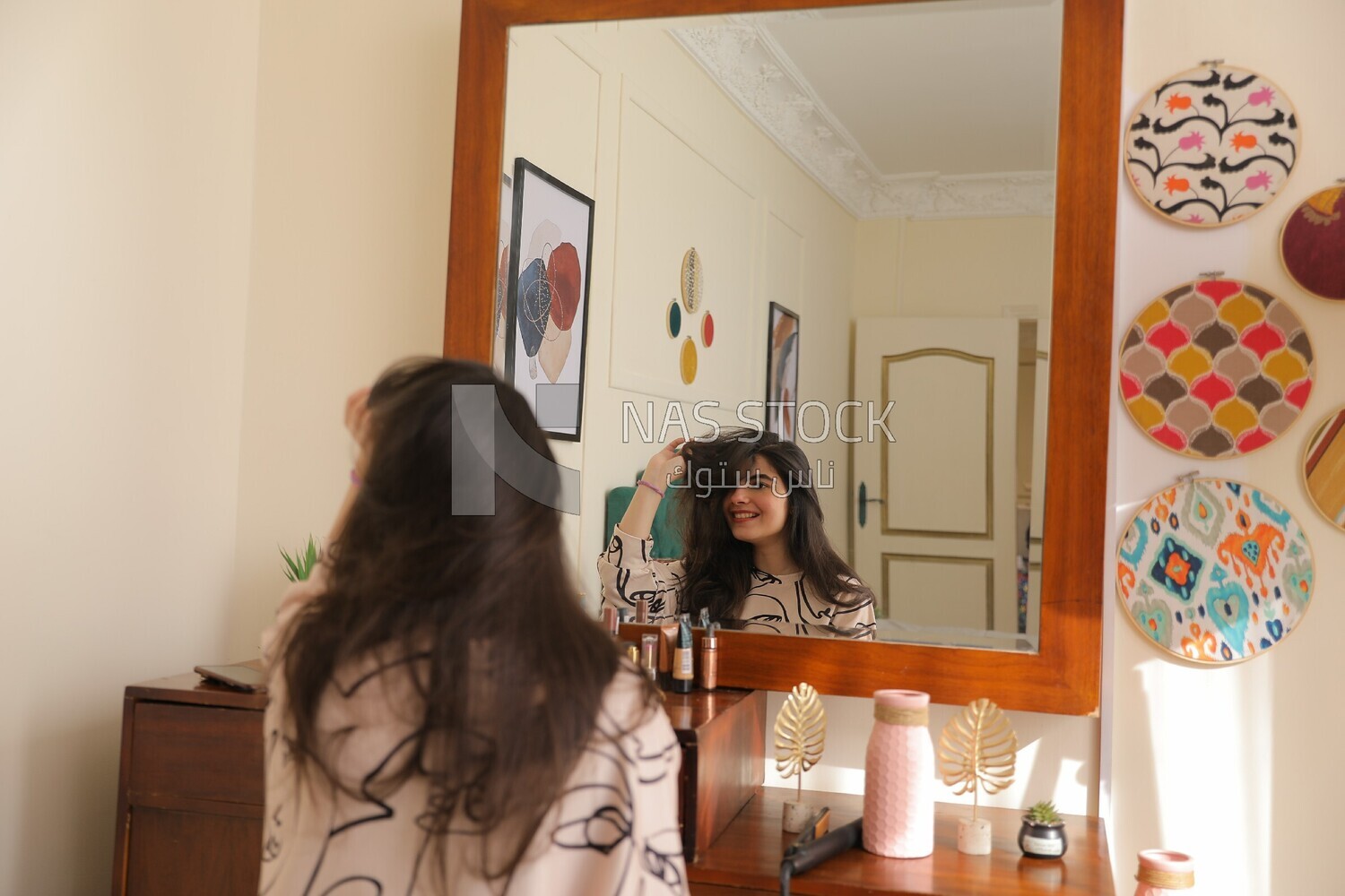 a woman sitting in front of the mirror