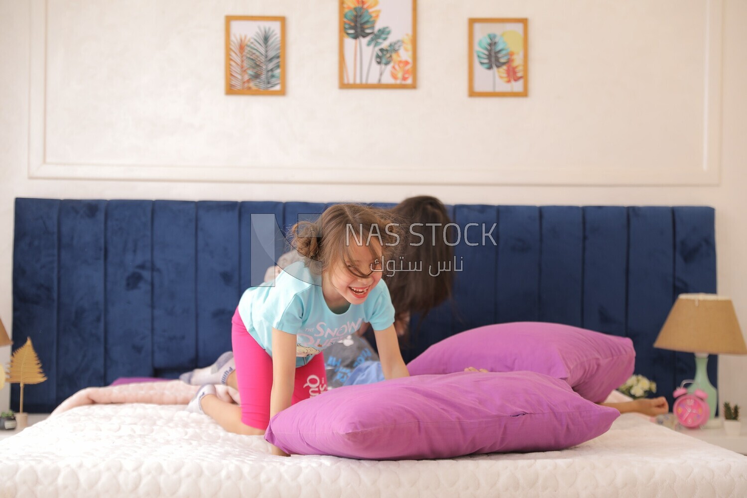a woman sitting with her children playing