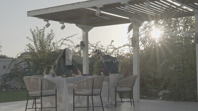 a family preparing a dining table in the garden