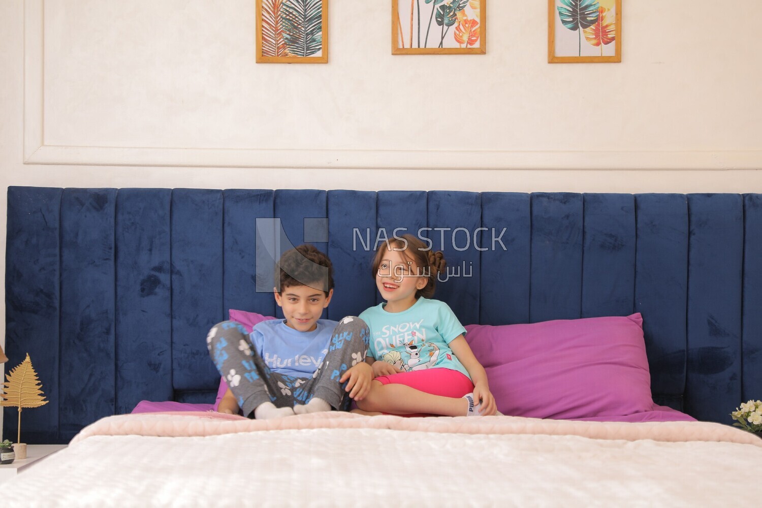 a brother and his sister lying in bed