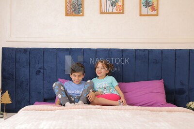 a brother and his sister lying in bed