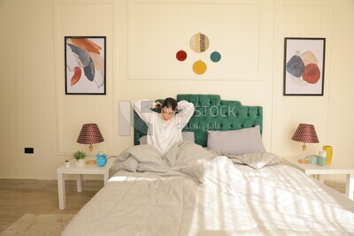 a woman sitting in bed waking up