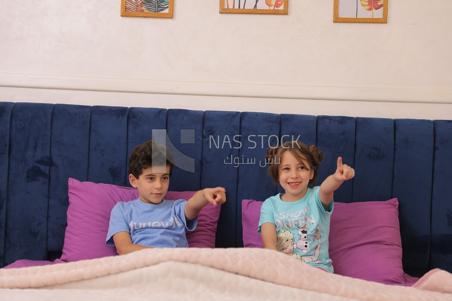 a brother and his sister lying in bed