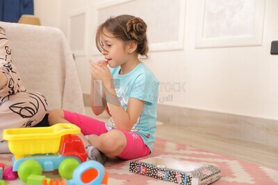 a girl putting on make up while she plays
