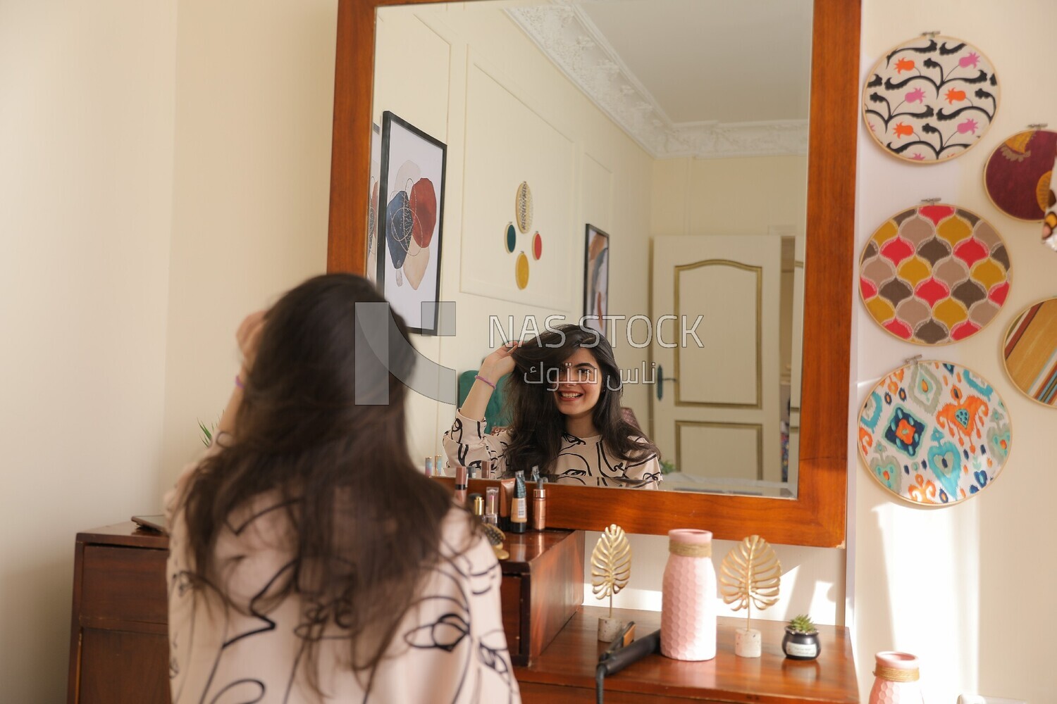 a woman sitting in front of the mirror