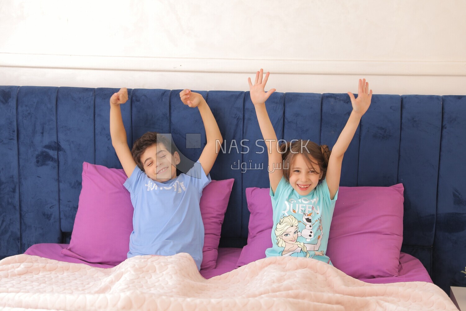 a brother and his sister lying in bed