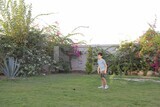 a boy playing in the garden