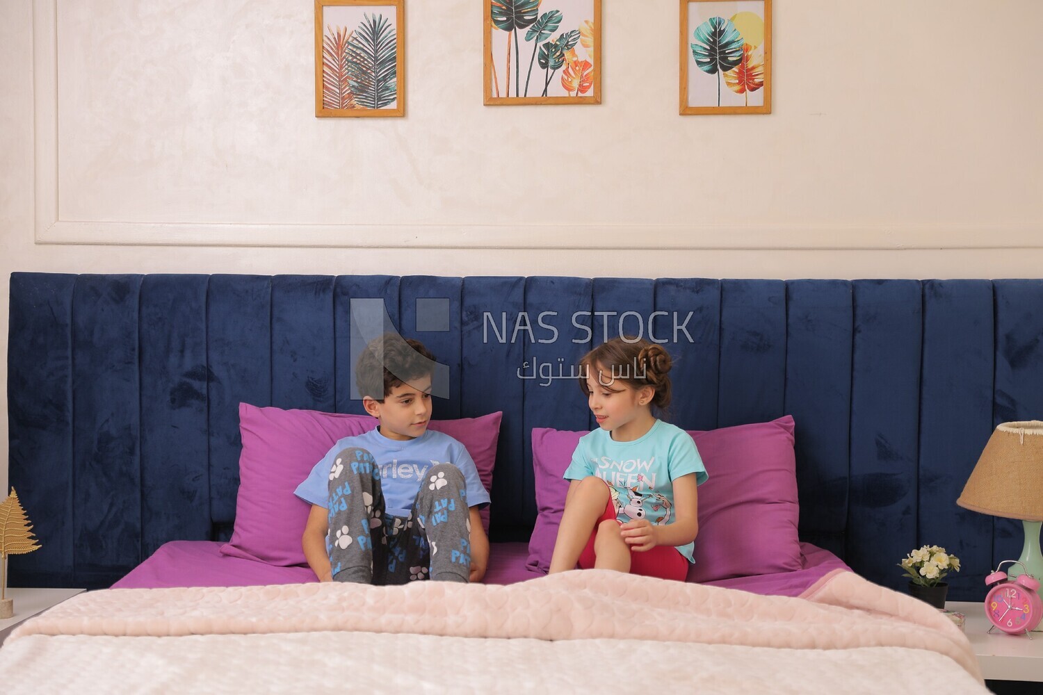 a brother and his sister lying in bed