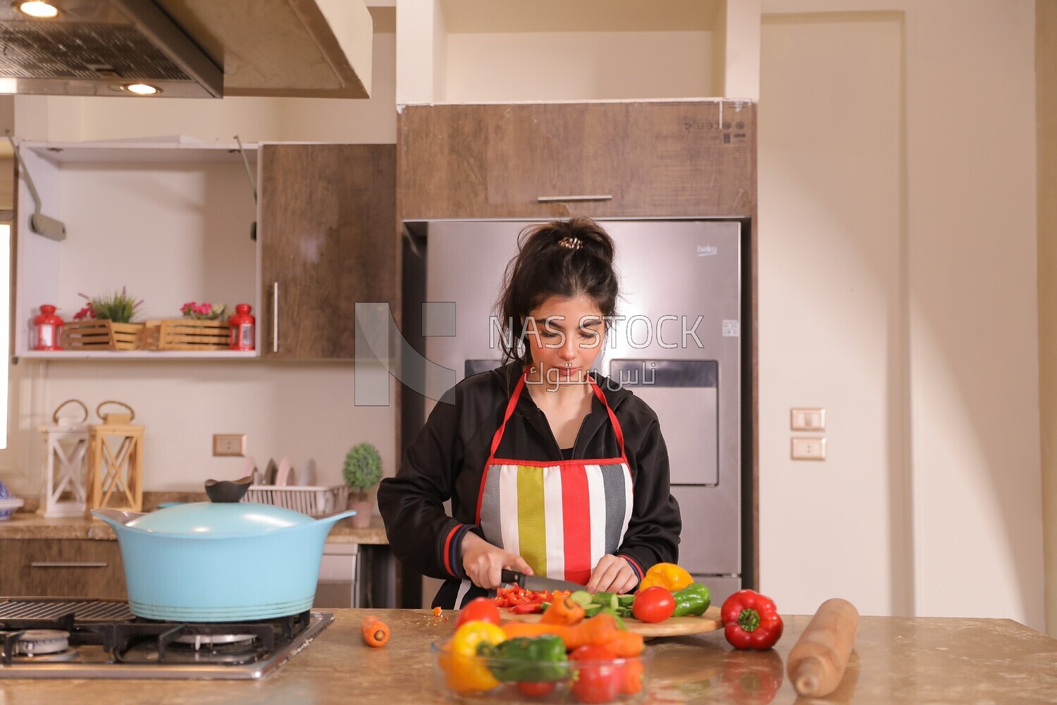 a woman cooking in the kitchen