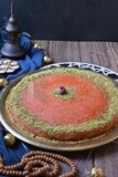 Plate of palestine knafeh with some nuts on it