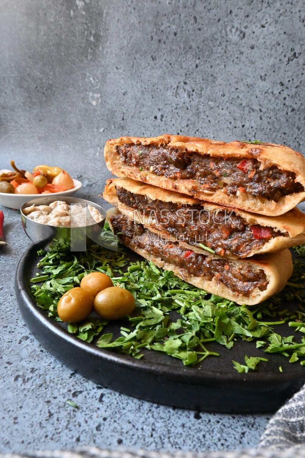 dish with hawawshi on it with fries.
