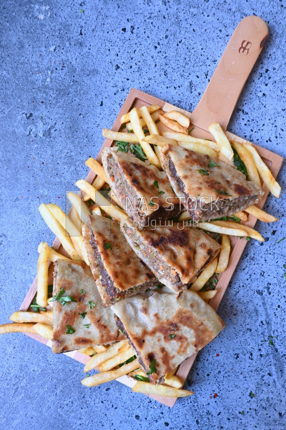 dish with hawawshi on it with fries