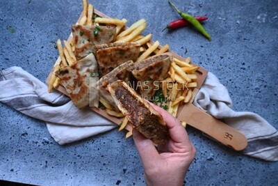 hand holding a hawawshi sandwich
