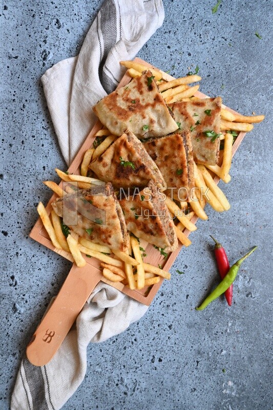 dish with hawawshi on it with fries